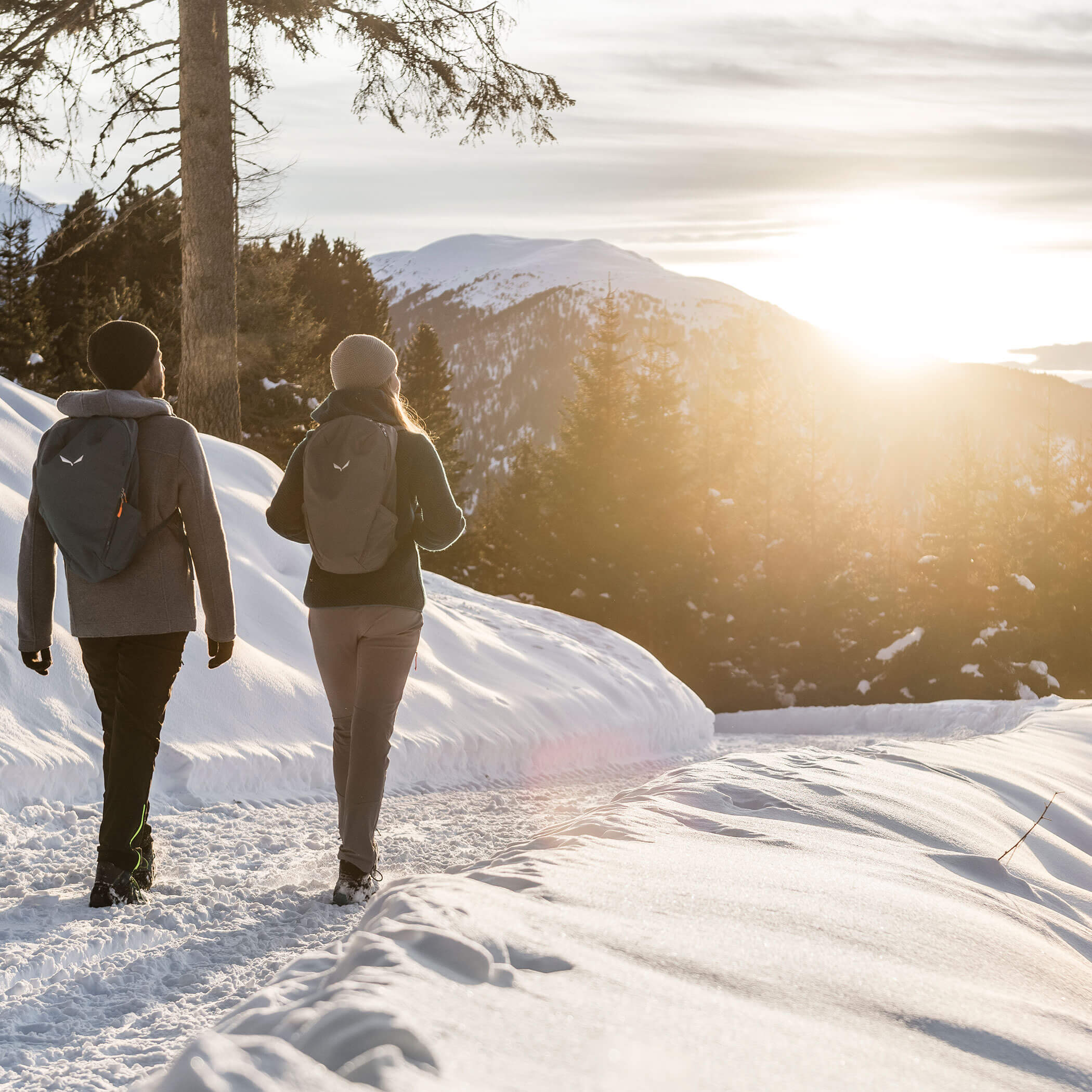 Couple walking along a snowy forest path - OLM Nature Escape